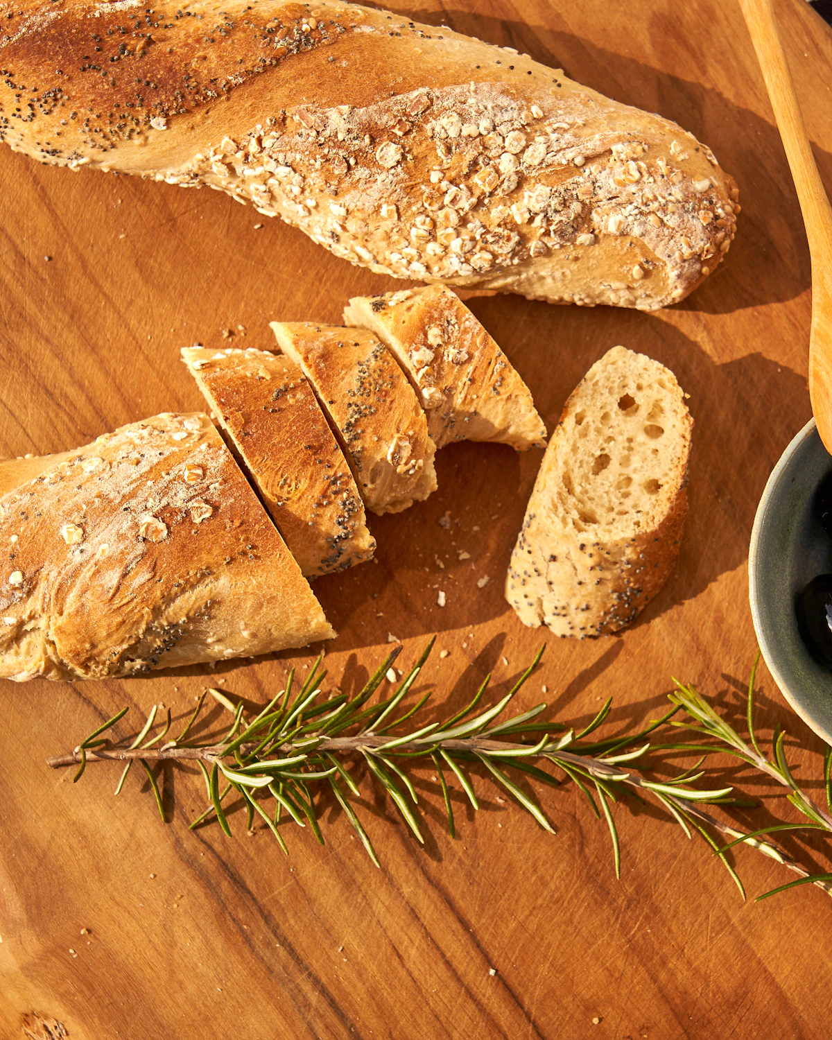 A rustic kitchen table with bread and olive oil.